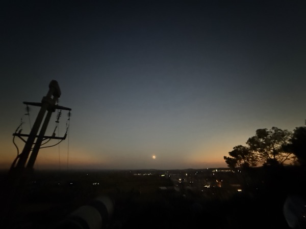 The moon's shadow visible in the sky