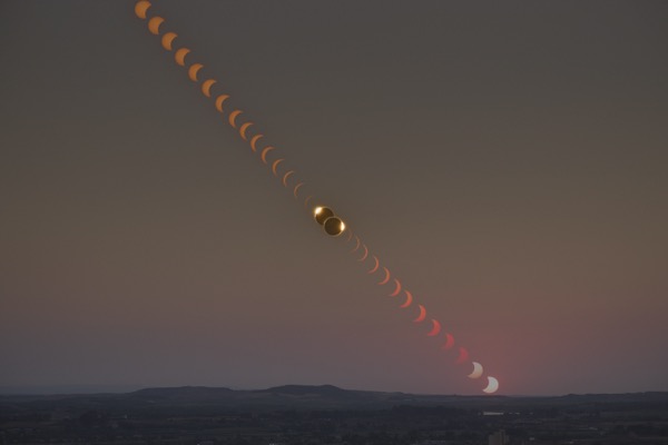 Total solar eclipse time lapse showing partials, totality, and sunset